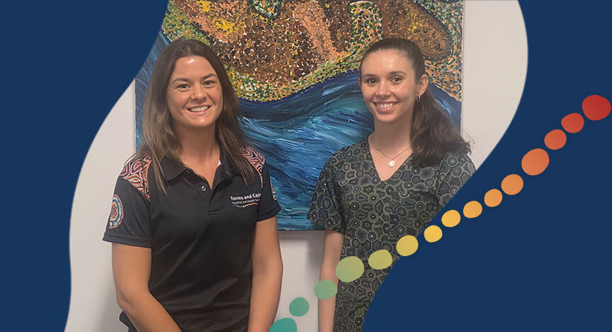 2 women standing in front of a painting
