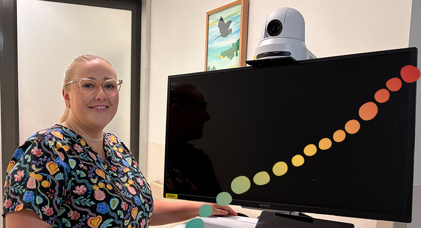 Woman standing next to a portable digital screen with camera